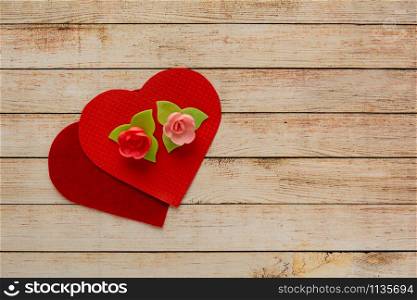 Wooden background with flowers and hearts. The concept of Valentine Day.
