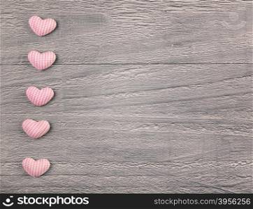 wooden background with gingham hearts toning in vintage style