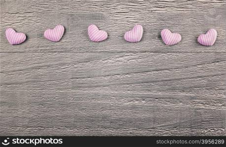 wooden background with gingham hearts toning in vintage style