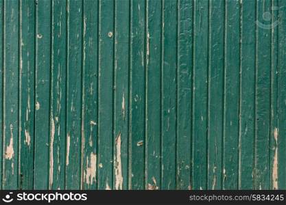 Wooden background with weathered paint in teal color
