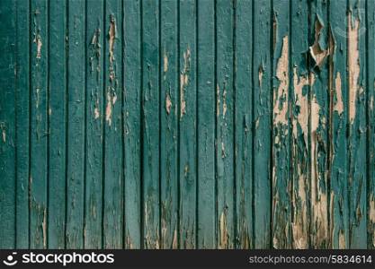 Wooden background with worn paint in teal color