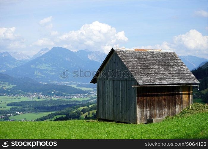 Wooden barn on the green pasture and valley in Lichtenstein