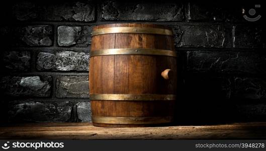 Wooden barrel and black brick wall in cellar