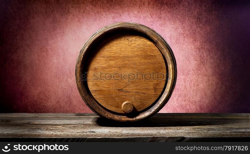 Wooden barrel on a textured pink background