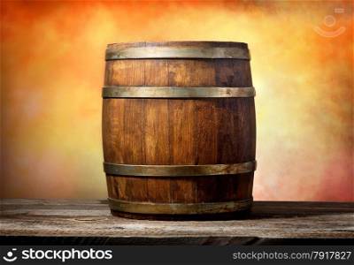Wooden barrel on a yellow-red background