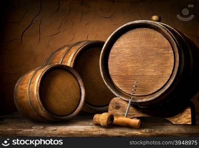 Wooden barrels and corkscrew in clay cellar