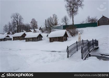 Wooden baths on black, standing on the bank of a small river on a winter day in the village of Vyatskoe, Russia.