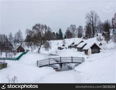Wooden baths on black, standing on the bank of a small river on a winter day in the village of Vyatskoe, Russia.