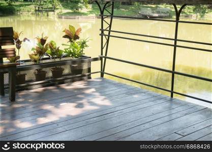 Wooden bench in a water house garden, stock photo