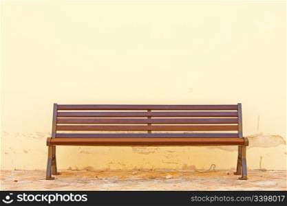 Wooden bench in front of the wall