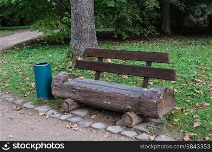 Wooden bench made of tree trunk in the park