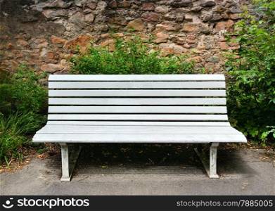 Wooden bench near a stone wall