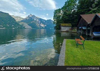 Wooden bench near Traunsee summer lake (Traunkirchen, Austria).