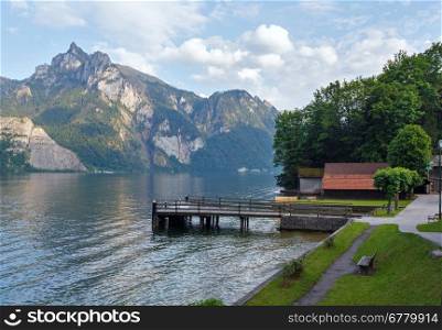 Wooden bench near Traunsee summer lake (Traunkirchen, Austria).