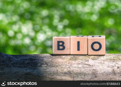 Wooden bio sign in green surroundings in the spring