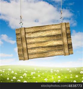 Wooden blank banner. Wooden blank banner hanging on ropes. Place for text