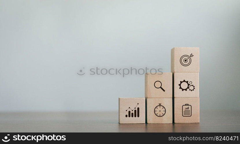 wooden block business strategy action plan The goals of entrepreneurs Pile of wood on the table with icons about business strategy and action plan. business development concept copy space