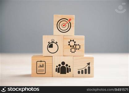 Wooden block cude step on table with Action Plan, Goal, and Target icons. Success and business target concept. Project management and company strategy symbolize growth.