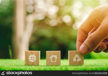 wooden block icon with hand touching With technology joining hands with environment icons through the connection of the environment.