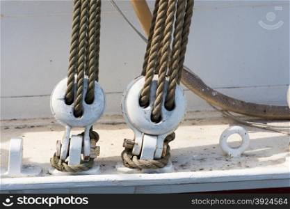 Wooden block tackle marine rigs and ropes. Detail of wooden block tackle marine rigs and ropes