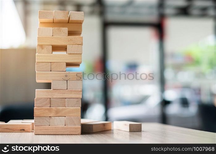 wooden block tower on office background. Business planning, Risk Management, Solution and strategy Concepts