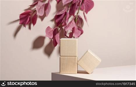 wooden blocks on a beige background. Concept scene stage showcase for product, promotion, sale, presentation of cosmetic products