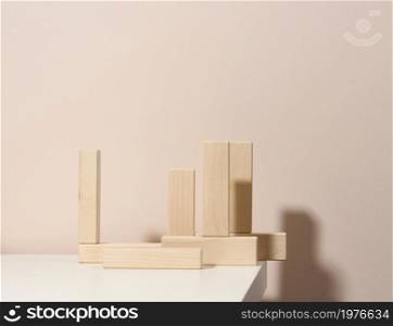 wooden blocks on beige background. Concept scene stage showcase for product, promotion, sale, presentation of cosmetic products