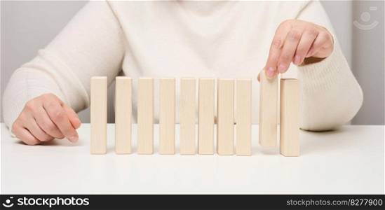 Wooden blocks on the table, a woman’s hand holds one. The concept of finding unique, talented employees