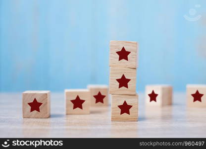 wooden blocks with the star symbol. Customer reviews, feedback, rating, ranking and service concept.