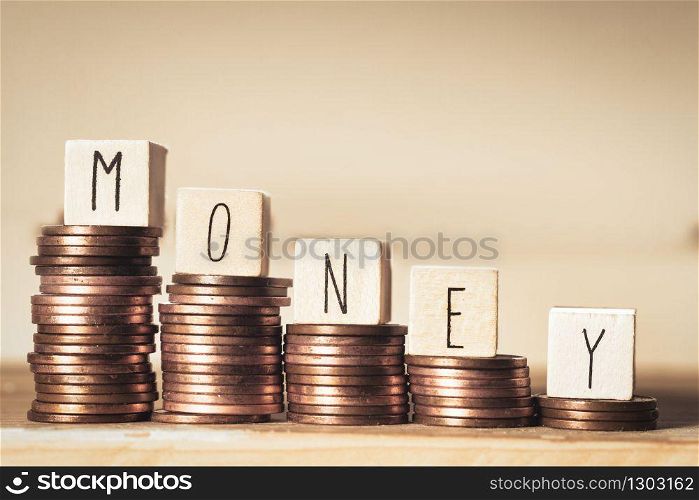 Wooden blocks with the word Money and a pile of coins, Money climbing stairs, business concept background. Wooden blocks with the word Money and a pile of coins, Money climbing stairs, business concept