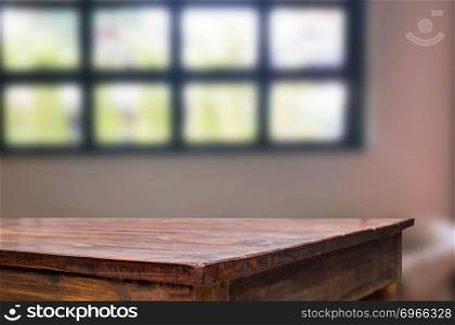 Wooden board empty table space platform in front of blurred Living Room Of The background - can be used for display or montage your products. Mock up for display of product.