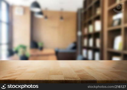 Wooden board empty Table Top And Blur Interior over blur in coffee shop Background, Mock up for display of product.