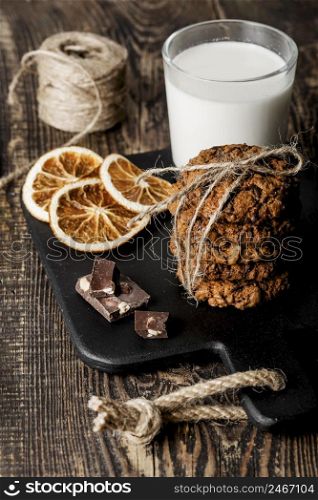 wooden board with delicious cookies milk