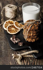 wooden board with delicious cookies milk