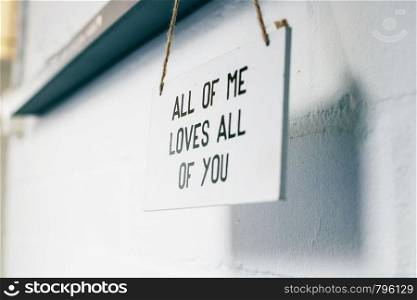 Wooden board with text all of me loves all of you, love sign on the wall home interior modern decoration romantic texture. Wooden board with text all of me loves all of you, love sign on the wall home interior modern