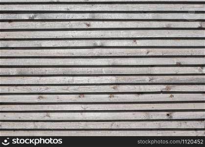 Wooden boards wall with shadows closeup as wooden background
