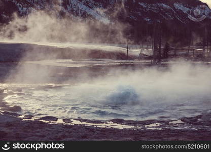 Wooden boardwalk along geyser fields in Yellowstone National Park, USA