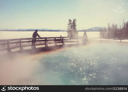 Wooden boardwalk along geyser fields in Yellowstone National Park, USA