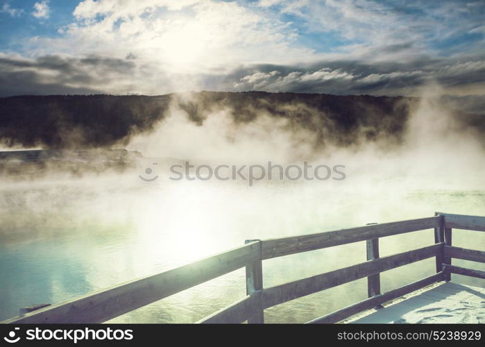 Wooden boardwalk along geyser fields in Yellowstone National Park, USA