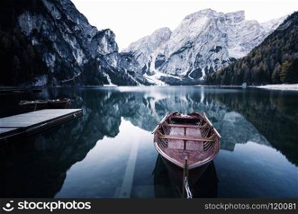 Wooden boat at the alpine mountain lake. Lago di Braies, Dolomites Alps, Italy. Wooden boat at the alpine mountain lake