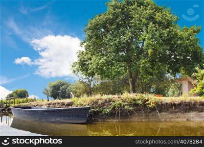 wooden boat in lake in village de Breca, in Briere Regional Natural Park, France
