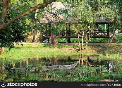 Wooden boat on the lake in asian forest, Cambodia