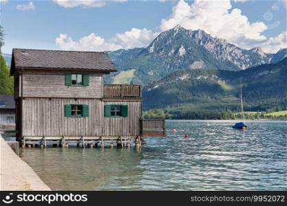 Wooden boathouse in Sankt Wolfgang am Wolfgangsee surrounded by alpine mountains. Wooden boathouse in Sankt Wolfgang am Wolfgangsee surrounded by alps