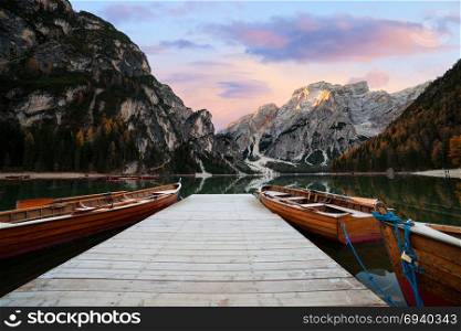 Wooden boats at the Alpine mountain lake. Lago di Braies, Dolomites Alps, Italy