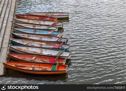 Wooden boats for hire moored on the River Thames, UK