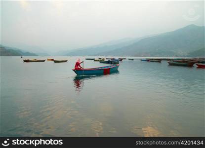 Wooden boats on the lake. Nepal evening.