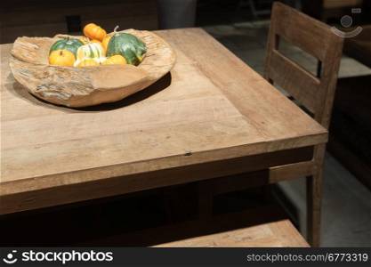 Wooden Bowl on Wooden Table with Autumnal Vegetables