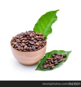 Wooden Bowl with coffee beans and coffee leaf on white background.
