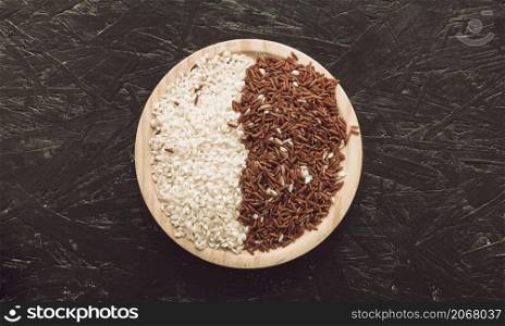 wooden bowl with raw red long grain jasmine white rice rough background