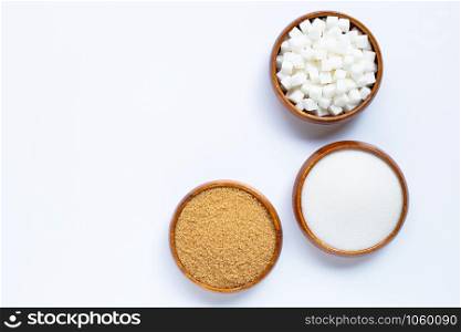 Wooden bowl with sugar on white background. Copy space
